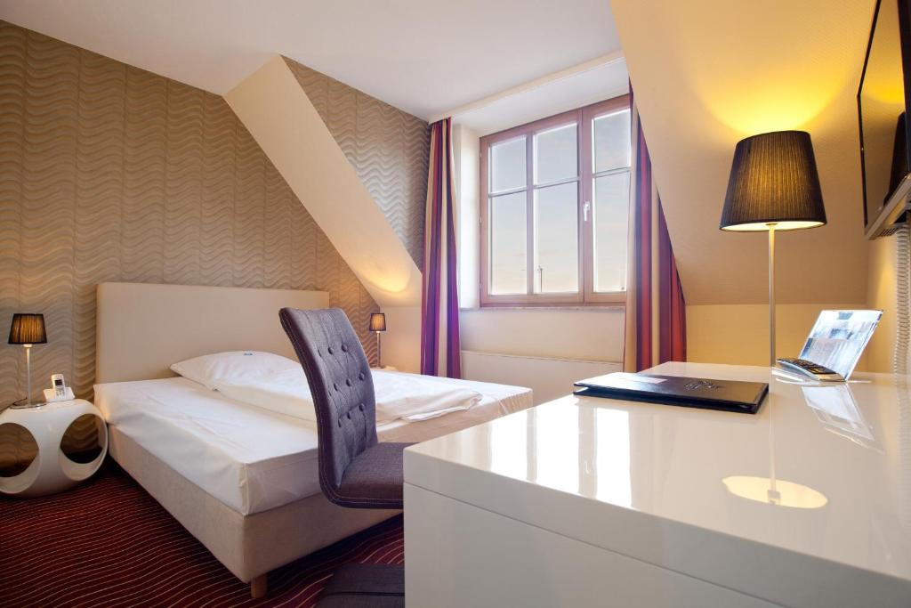 Postel nebo postele na pokoji v ubytování HKK Hotel Wernigerode