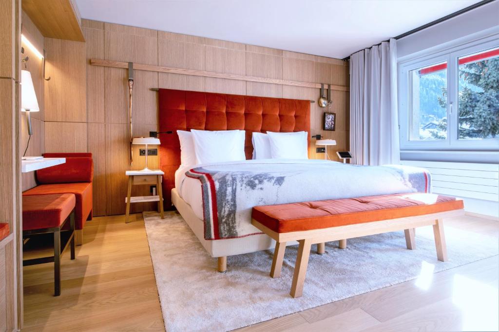 A bed or beds in a room at Schweizerhof Zermatt - a Small Luxury Hotel