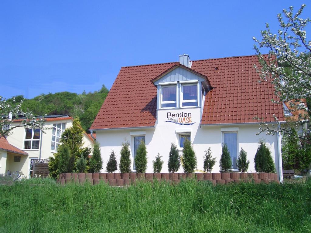 a white house with a red roof at Pension Fitnessoase in Eußenheim