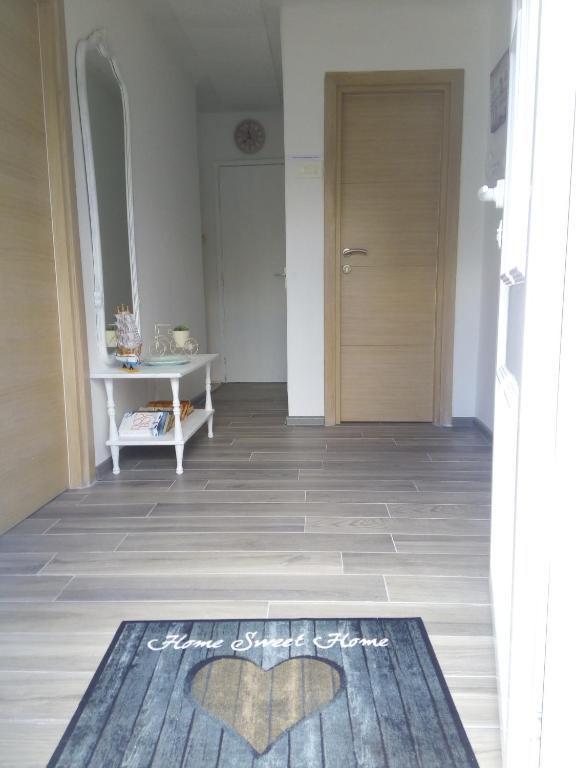 a hallway with a door and a rug on the floor at Vicky Apartments in Kotor