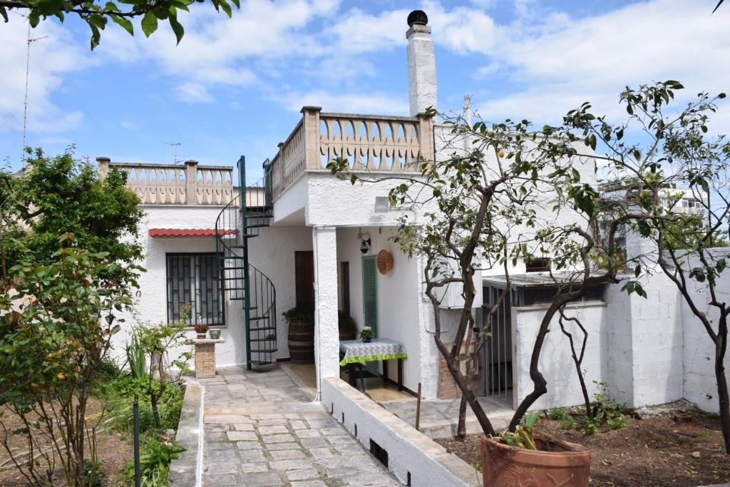 a white house with a balcony on top of it at Tonia's mansion in Bari