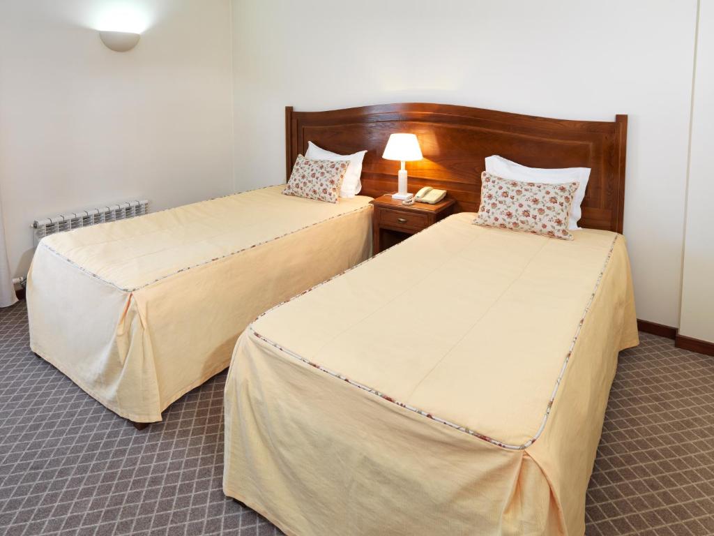 Cama ou camas em um quarto em Hotel Santa Maria