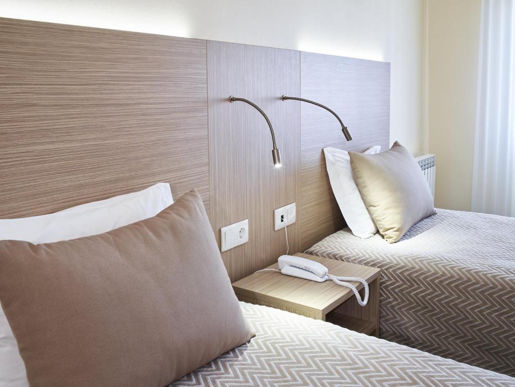 Cama ou camas em um quarto em Hotel Santa Maria