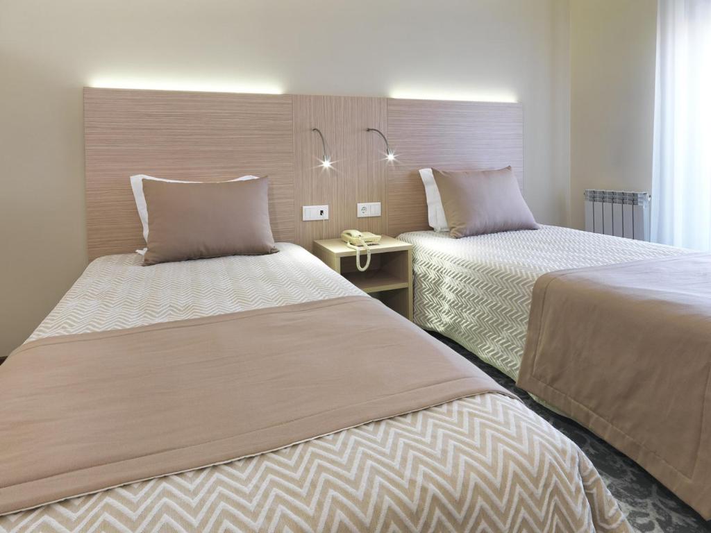 Cama ou camas em um quarto em Hotel Santa Maria