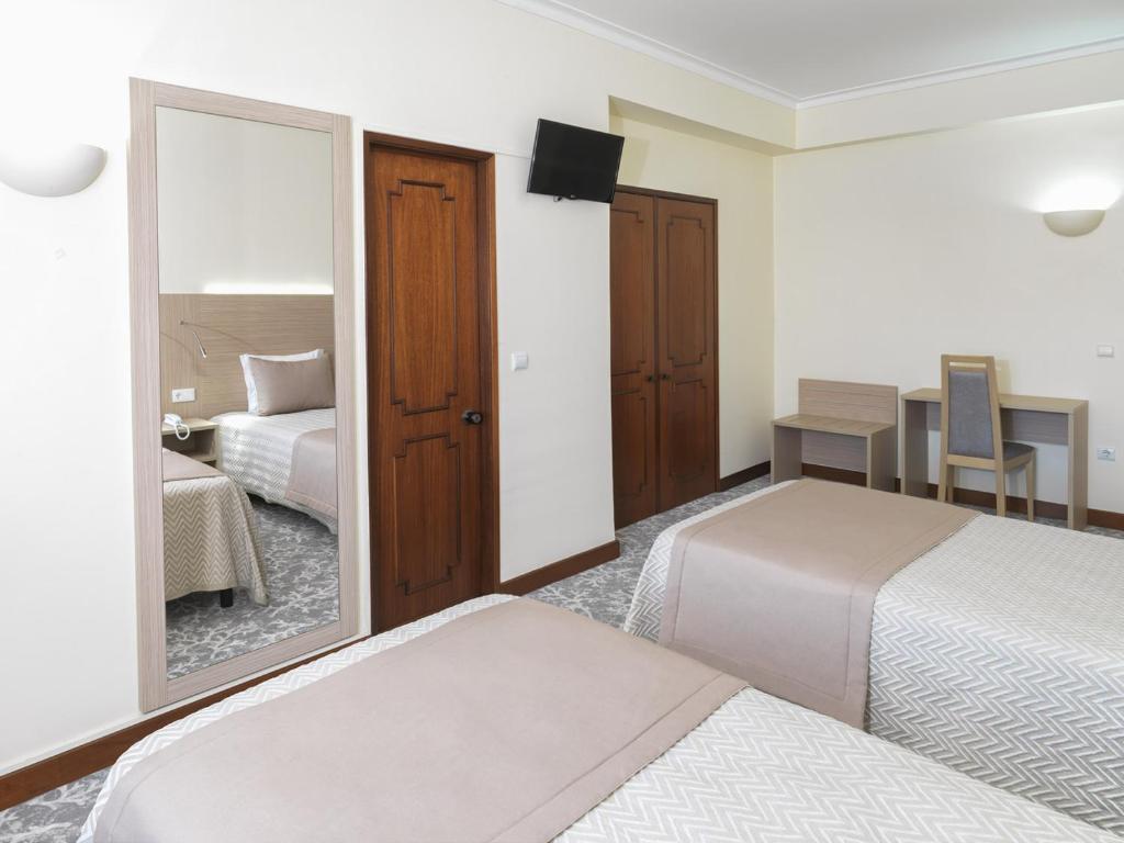 Cama ou camas em um quarto em Hotel Santa Maria