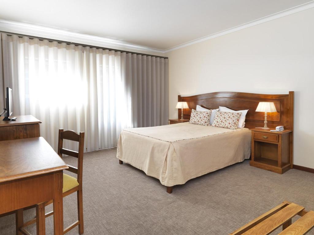 Cama ou camas em um quarto em Hotel Santa Maria