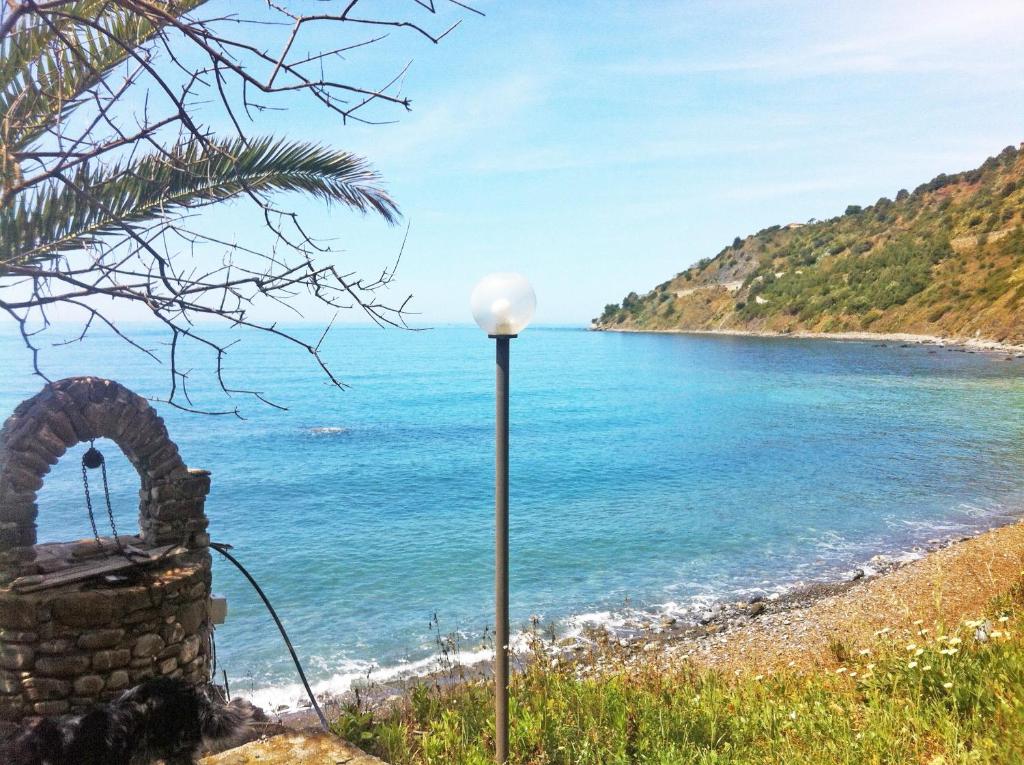 a street light on a beach near the water at Villa Calamona in Acciaroli
