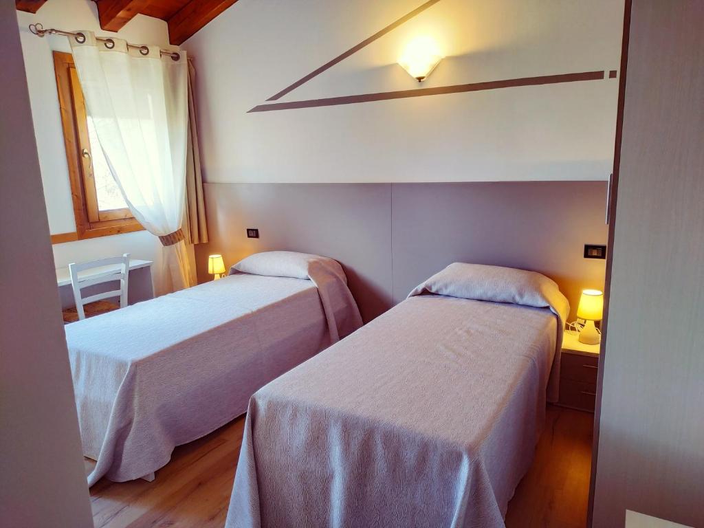 A bed or beds in a room at Agriturismo le Colonie