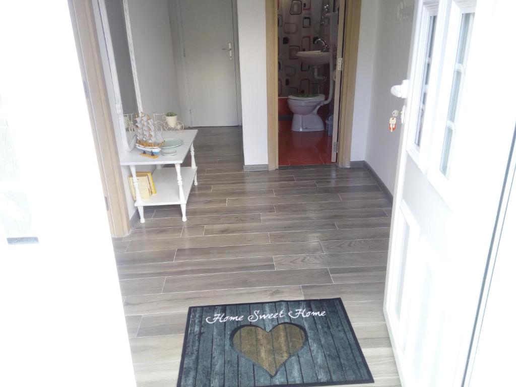 a hallway with a heart rug on the floor at Vicky Apartments in Kotor