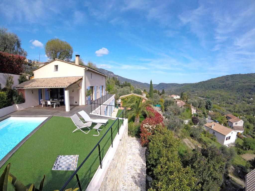 a villa with a swimming pool and a house at Villa Zola Apartment, the magic of the French Riviera in Le Bar-sur-Loup
