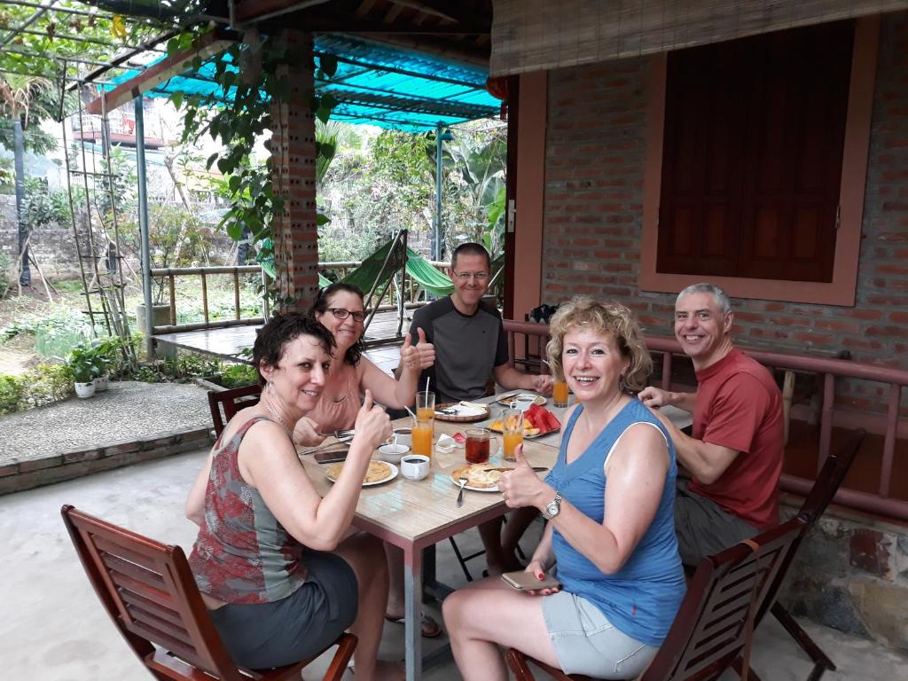 a group of people sitting around a table at An Phu Homestay in Ninh Binh