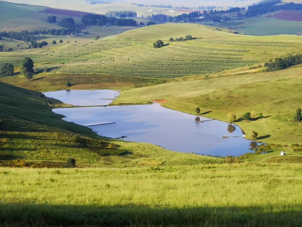 a hillside with two reservoirs in a field of grass at Forty Winks in Nottingham Road