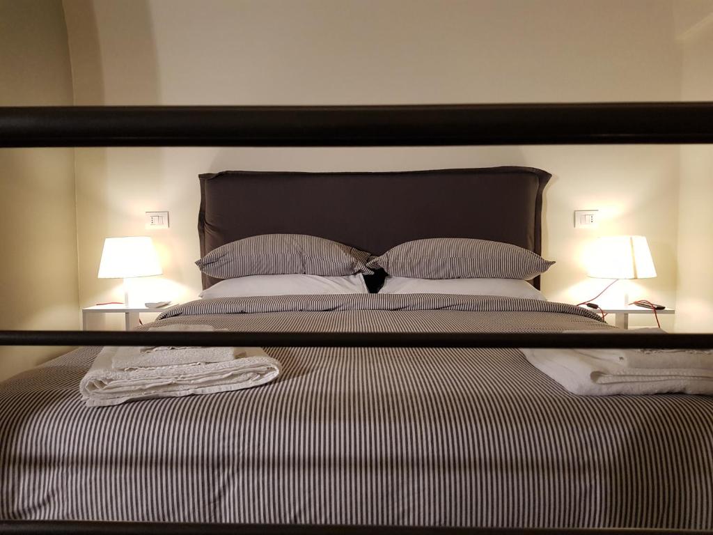 Posteľ alebo postele v izbe v ubytovaní MammaDada charm rooms