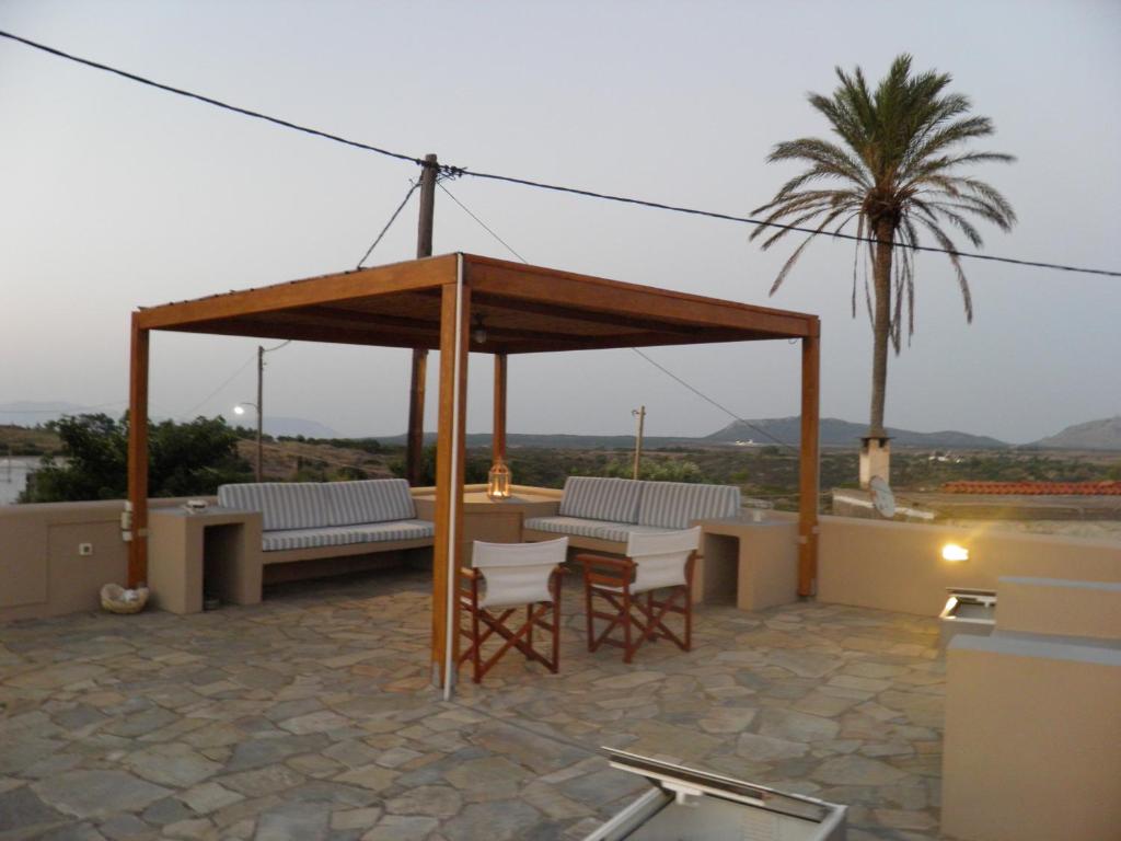 a gazebo with two chairs and a table at Kytherian Traditional Home in Frilingiánika