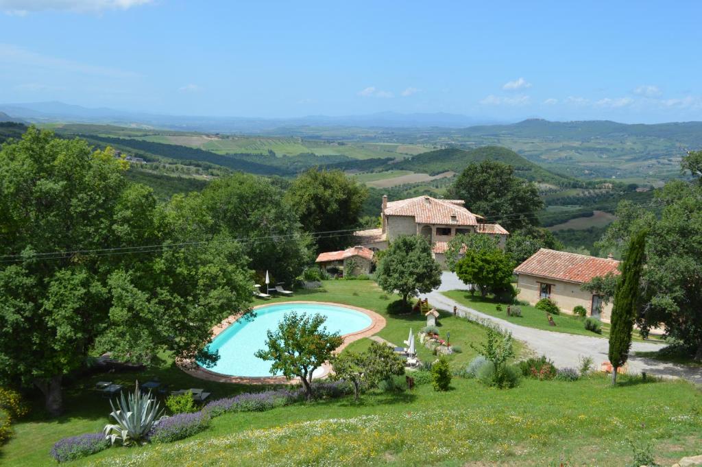 an external view of a villa with a swimming pool and a house at Bellavista in Seggiano