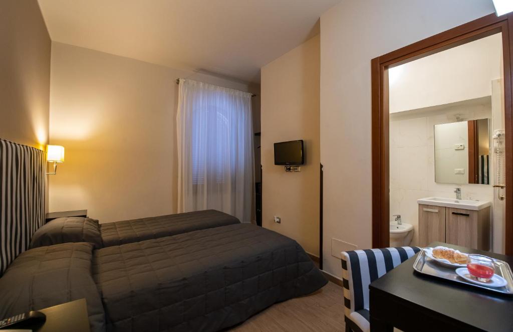 Postel nebo postele na pokoji v ubytování Hotel Moderno