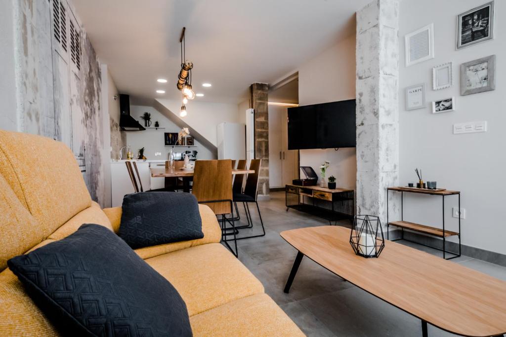 a living room with a couch and a table at Casa Rural Peña Gamella in Herreros