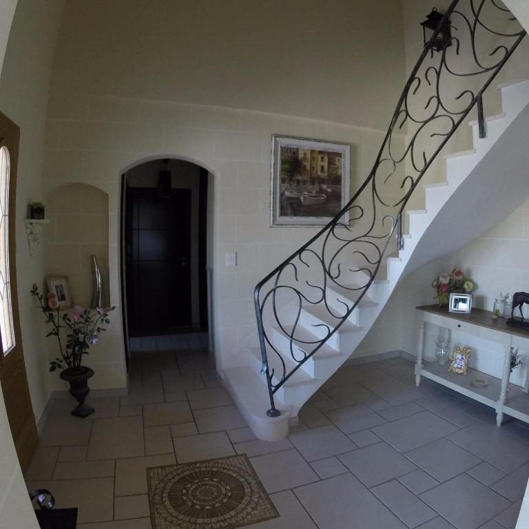a staircase in a house with a stair case at Villa du Courboulay in Sargé Les Le Mans 
