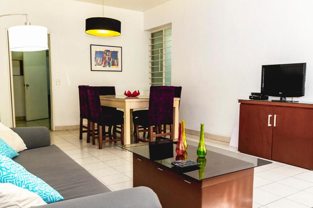 a living room with a couch and a table at Minerva Apartments in Guadalajara