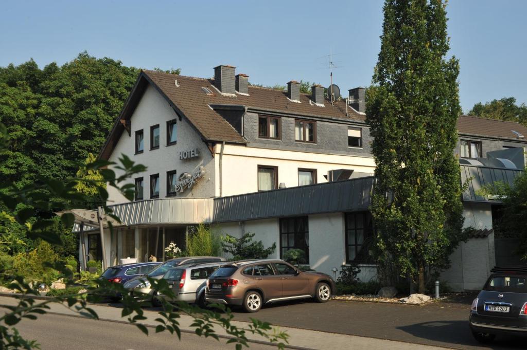 a building with cars parked in front of it at Hotel Spiegel in Cologne