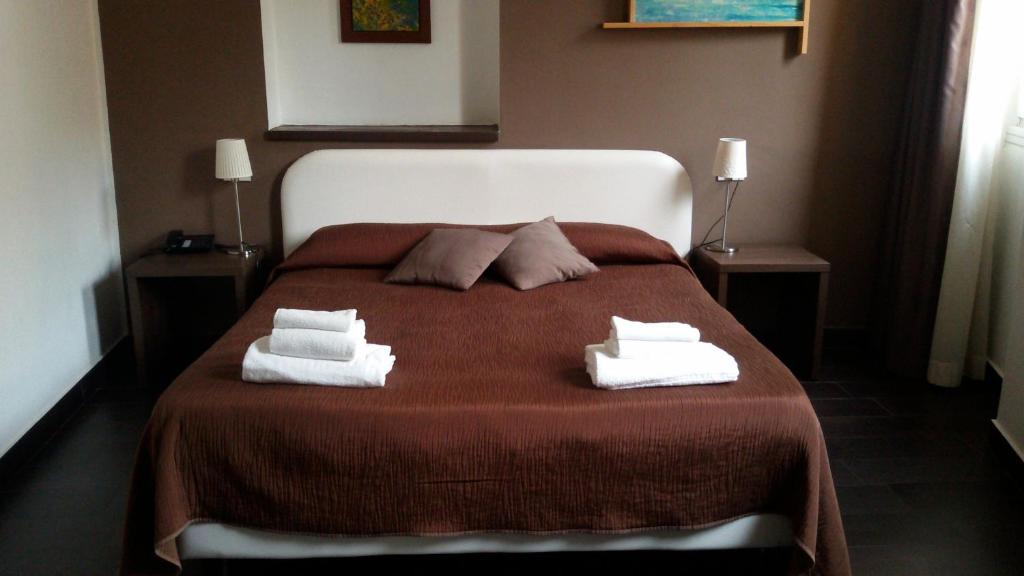 Postel nebo postele na pokoji v ubytování Hotel Corte Santa Libera