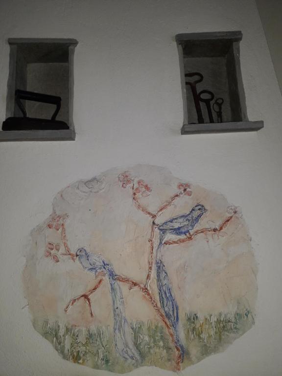 a painting of two people on a wall at Vera's Traditional House in Zagora