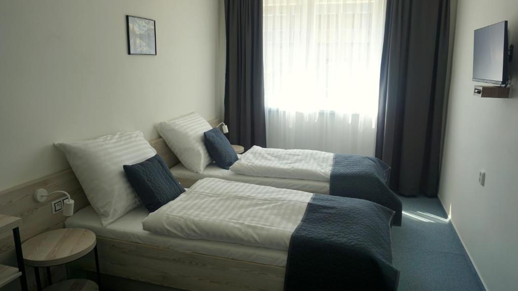 Postel nebo postele na pokoji v ubytování Hotel Metropol CB