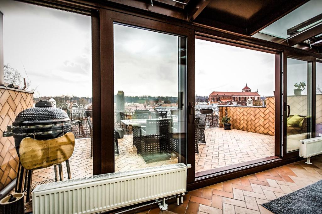 a room with windows and a view of a harbor at Apartment with a Terrace over the Old Town Two Bedrooms in Kaunas