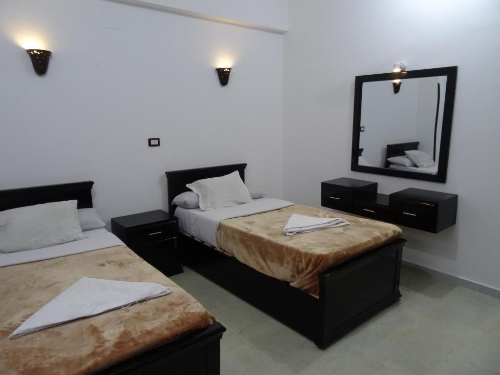 A bed or beds in a room at Nile Sunrise Flats