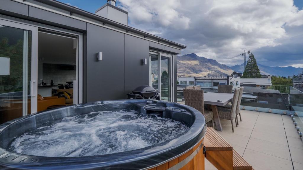 a hot tub on the balcony of a house at Diamond Deluxe Central Queenstown in Queenstown
