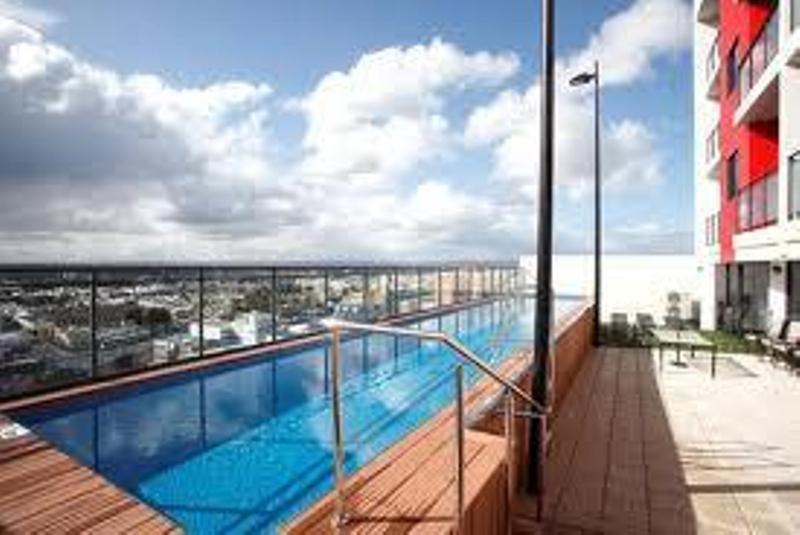 a swimming pool on the balcony of a building at Astra Apartments Perth - Zenith in Perth