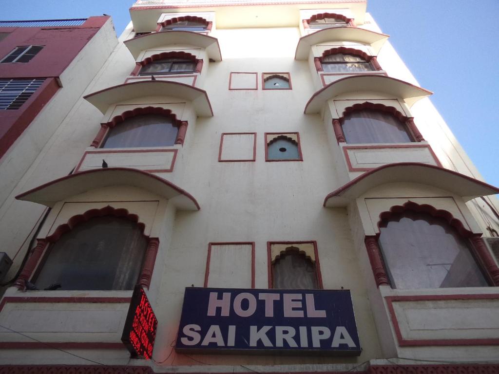 a hotel sign in front of a building at Hotel Sai Kripa in Jaipur