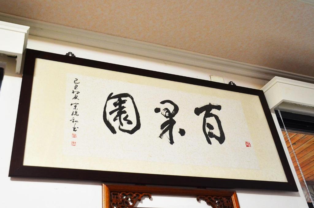 a framed sign with asian writing on a wall at Kaohsiung Meinong Rabbit Paul Homestay B&B in Meinong