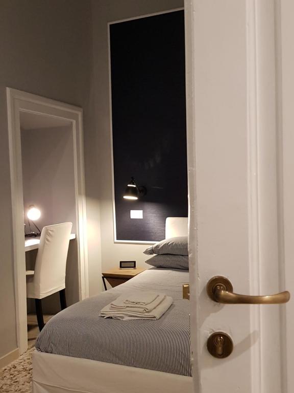 Posteľ alebo postele v izbe v ubytovaní MammaDada charm rooms