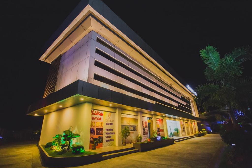 a building with lights on it at night at Hotel Costa Brava in Tacloban