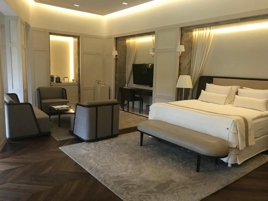 a bedroom with a bed and a living room at Kemer Country Hotel İstanbul in Istanbul