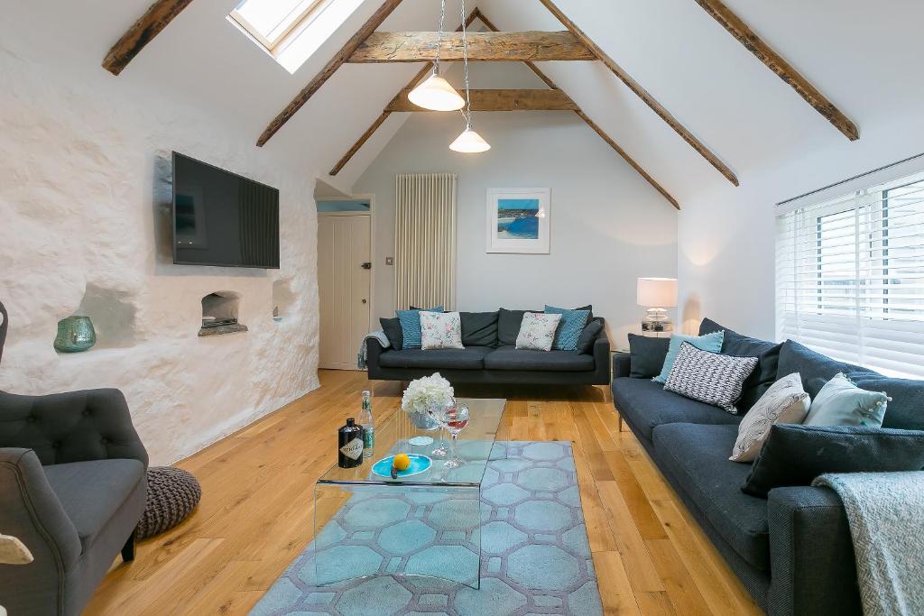 a living room with a blue couch and a table at The Moorings in St Ives