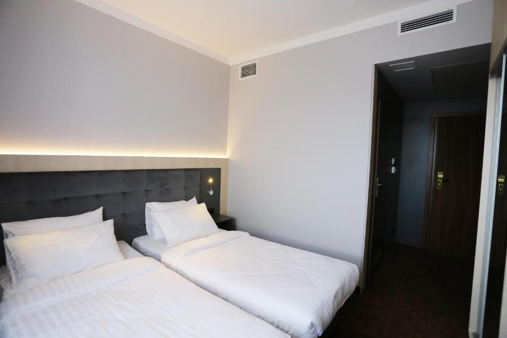 Posteľ alebo postele v izbe v ubytovaní euroHOTEL Sosnowiec Kazimierz