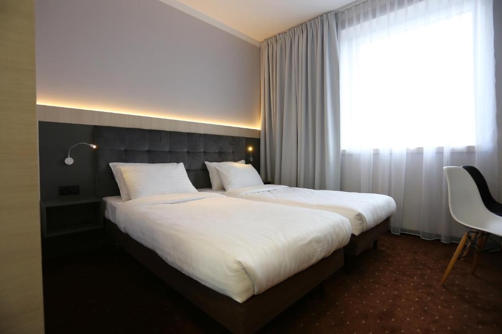 Posteľ alebo postele v izbe v ubytovaní euroHOTEL Sosnowiec Kazimierz
