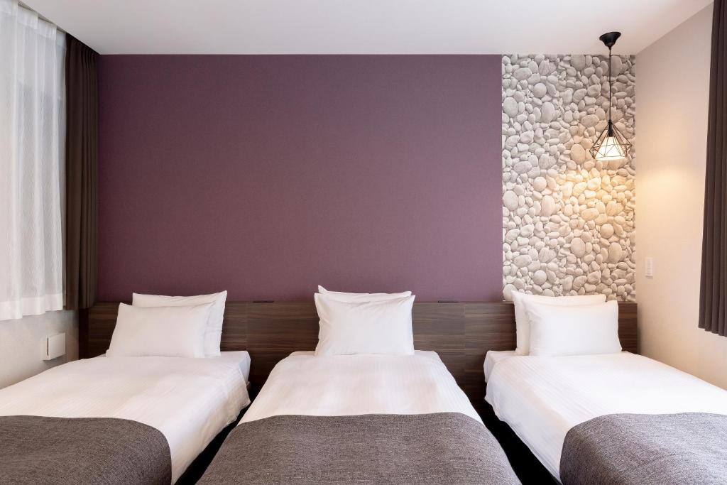 Postel nebo postele na pokoji v ubytování M's Hotel Gojo Naginatagiri