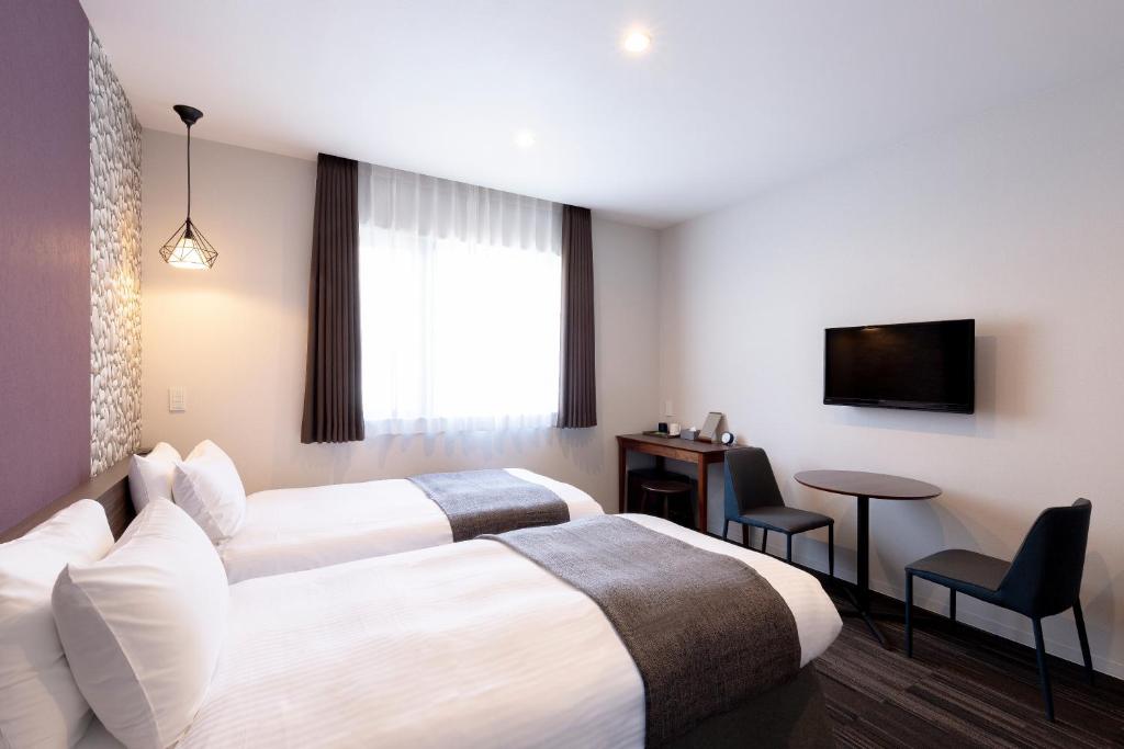 Postel nebo postele na pokoji v ubytování M's Hotel Gojo Naginatagiri