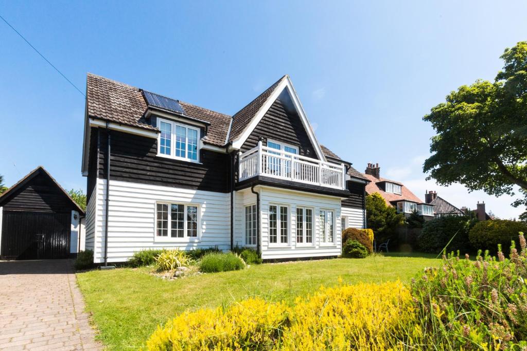 a house with a black and white house at Lake Cottage in Thorpeness