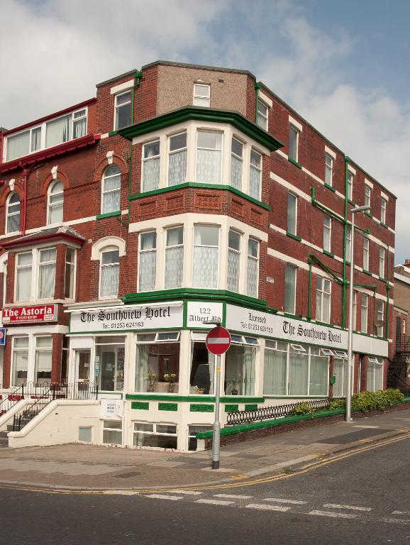 a large brick building on a street with a stop sign at Southview Hotel in Blackpool