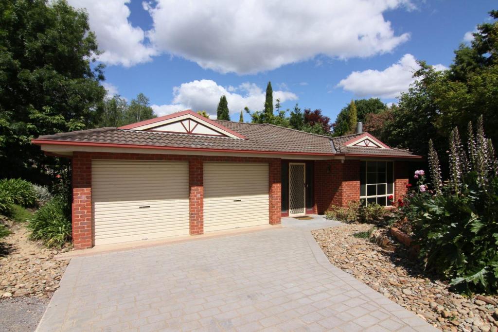 a house with two garage doors in a driveway at 12 Mount Porepunkah Road in Bright