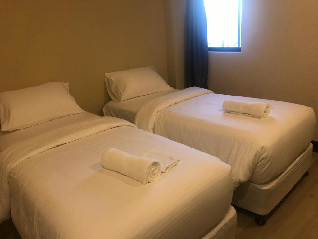 Postel nebo postele na pokoji v ubytování Babylon Oslob Coast Guesthouse