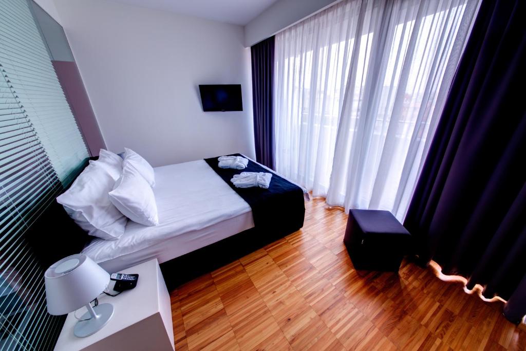 Postel nebo postele na pokoji v ubytování Sarroglia Hotel