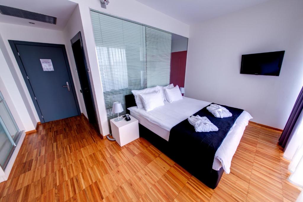 Postel nebo postele na pokoji v ubytování Sarroglia Hotel