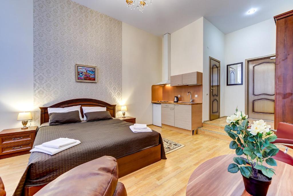 a bedroom with a bed and a couch at Guest rooms on Kirochnaya 22 in Saint Petersburg
