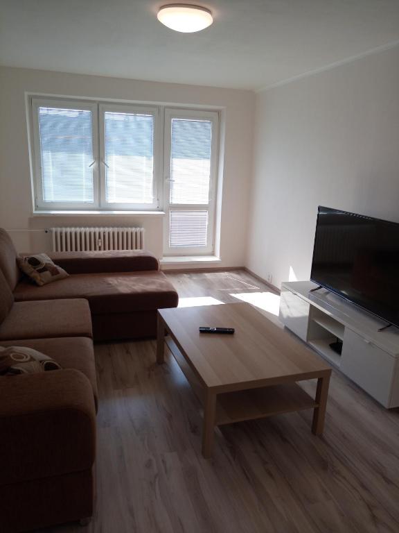 a living room with a couch and a coffee table at Apartmány Karviná in Karviná