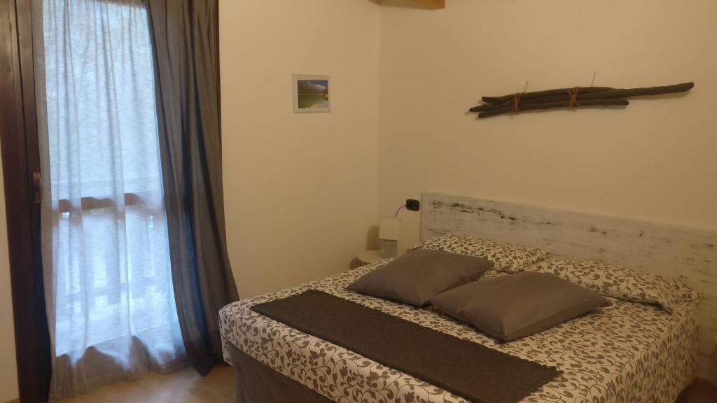 Postel nebo postele na pokoji v ubytování Garnì Al Laghet